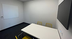 Teen Study Room with Table and Four Chairs, LCD Monitor and Dry Erase Board on wall