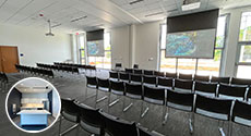 chairs in front of two projector screens and windows with kitchen photo inset