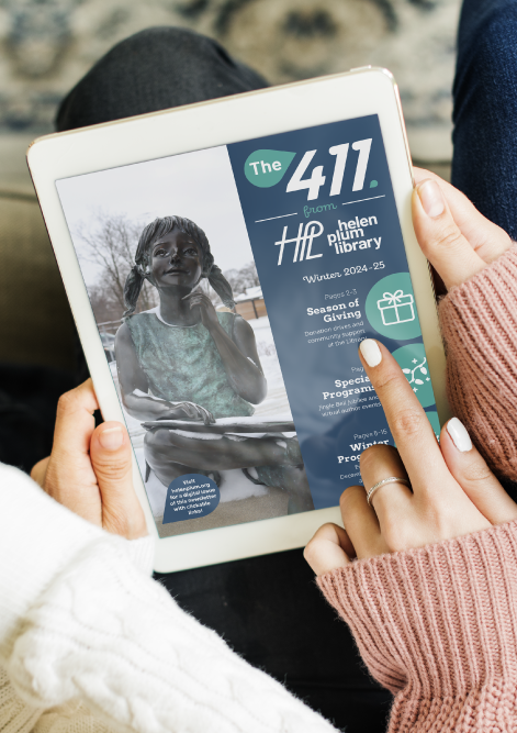 Two women wearing knit sweaters looking at a tablet with the winter 411 newsletter on screen