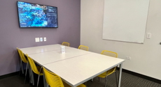 Photo of Youth Study Room A with a table, six chairs, and LCD screen