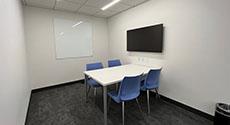 Photo of Study Room B with a table, four chairs, and LCD screen